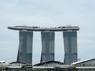 Marina Bay Sands hotel photographed frontally in bright even daylight, clean sky, architectural precision, calm institutional light, no tourism drama