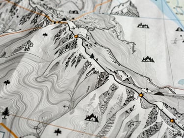 Close-up of fine cartographic line work showing contour intervals and custom mountain icons on a mountain resort map, natural light.