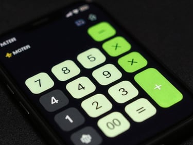Close-up macro shot of a physical Android device displaying a sleek calculator app with neon green accents, high-contrast studio lighting, dark background, sharp focus.