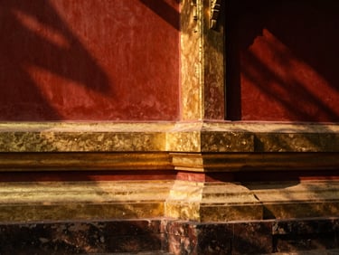 Quiet sunlit corner of an ancient Buddhist temple in Chiang Mai, golden reflections, soft shadows, warm editorial feel