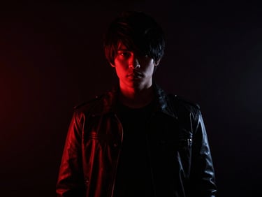 High-concept cosplay portrait in atmospheric dark setting, neon red accents, deep shadows, high contrast, 35mm
