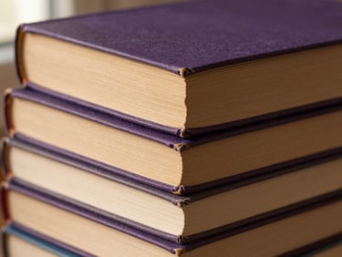 Close-up of stacked linen-bound books with worn spines, soft side lighting, warm paper textures