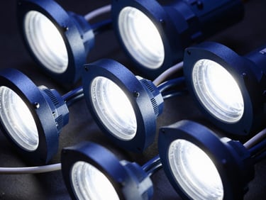 Detailed shot of modern LED lighting fixtures and electrical cables, showcasing intricate wiring and bright illumination, studio lighting, deep blue and metallic tones, high contrast.