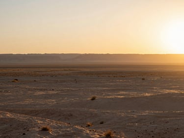 Expansive and peaceful Southern Utah desert landscape at sunrise, soft golden-hour light, low horizon, wide shot
