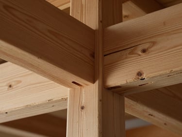 Extreme close-up of heavy timber joinery, showing raw wood grain and precise cuts under natural side-light.