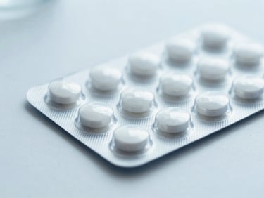 Close-up of a sterile blister pack of medication on a clean white surface, soft clinical lighting, no people