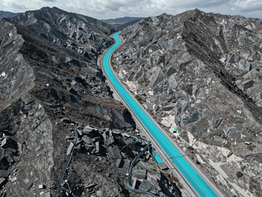 Crisp technical photography of a top-down orthomosaic map showing a pipeline corridor crossing rugged mountain terrain, cool overcast daylight, high-contrast slate and cyan telemetry overlays, 35mm lens.