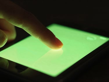 Macro close-up of a finger tapping a glowing green action button on a mobile screen, intense neon cyber lime glow, shallow depth of field