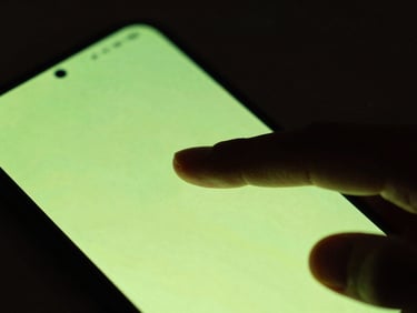 Extreme close-up of a finger tapping a sleek, glowing cyber-lime Android device screen, dark moody ambient background, shallow depth of field