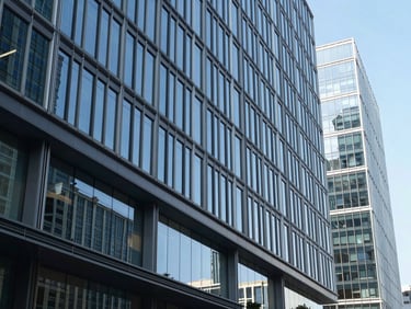 Crisp modern architectural lines of a corporate headquarters, natural daylight reflecting off glass facades, cool blue tones, sharp focus, 35mm lens