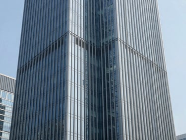 Clean architectural geometry of a modern financial district skyscraper, sharp daylight shadows