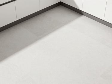 Top-down shot of modern geometric kitchen floor tiles in white and soft grey, clean daylight.