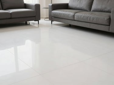 Sleek living room featuring high-gloss white vitrified floor slabs, neutral daylight, clean white and charcoal tones, sharp focus, 35mm lens