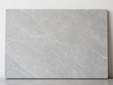 Straight-on close-up of a large-format grey vitrified slab with subtle white veining, neutral studio lighting.