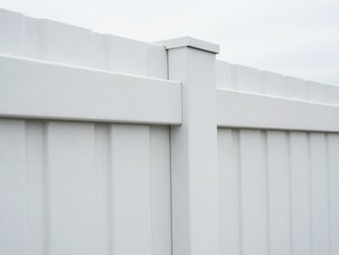 Close-up of a perfectly aligned white vinyl fence panel, highlighting clean lines and seamless connections, under crisp daylight.