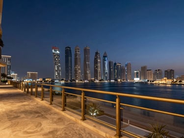 Dramatic high-angle twilight view of a luxury penthouse terrace overlooking Dubai Marina, brushed brass railings, deep navy evening sky.