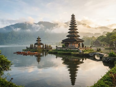 Ulun Danu Beratan temple on a calm lake in Bali, misty mountains in the background, soft morning light, 35mm lens.