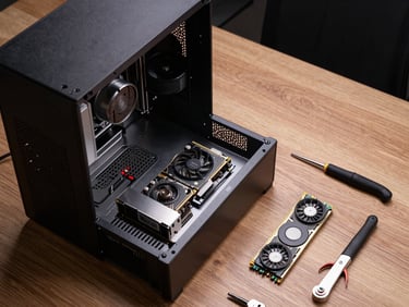 Overhead shot of a desktop computer tower open on a work table under studio lighting, RAM and GPU components clearly visible, tools arranged neatly beside it