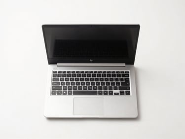 Overhead straight-on product shot of an HP refurbished laptop open on a white surface, clean studio lighting, no reflections