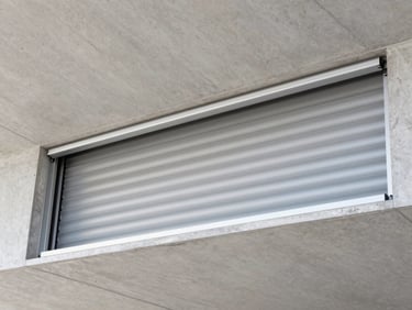 Close-up of a fully recessed roller screen cassette integrated invisibly into a modern concrete ceiling pocket, clean lines.