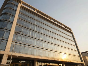 Wide-angle architectural view of a commercial building facade in DHA Karachi, clean glass panels, warm daylight