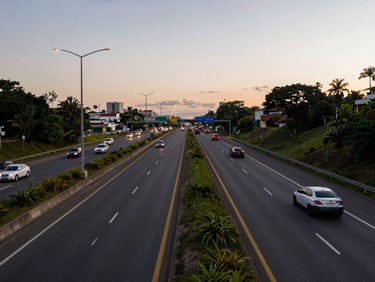 Wide shot of a Brazilian urban highway at dusk, lane markings and road signs visible, vehicles in motion, natural ambient light, no people in distress
