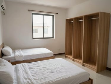 A well-maintained double sharing PG room for men with two separate single beds, clean tiled floor, and individual wardrobes under bright daylight.