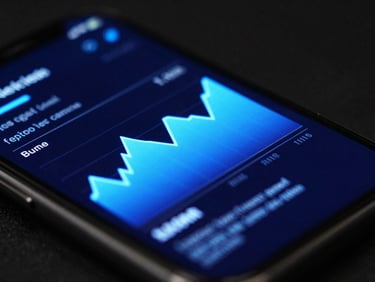 Extreme close-up macro shot of a mobile screen displaying a dark mode interface with vibrant neon blue glowing charts, dark ambient studio lighting, 35mm lens