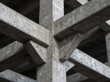 Macro detail of concrete and structural steel framework under dramatic high-contrast lighting