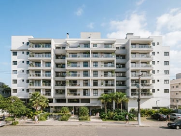 Realistic architectural photography of Vitória Ville apartment building exterior, bright natural daylight, clean white and light gray tones, 35mm wide-angle lens