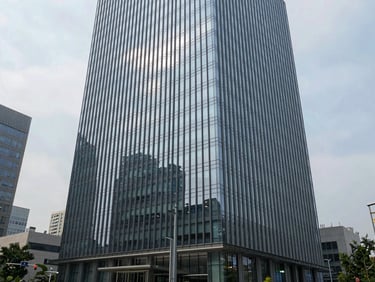 Full exterior rendering of a glass curtain-wall commercial tower in an urban context, precise mullion geometry, cool overcast daylight, street-level perspective showing full building height
