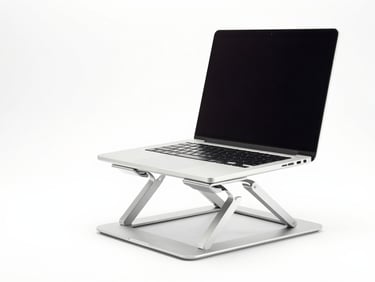 An aluminum laptop stand holding a modern silver laptop, clean white background, bright studio light, sharp focus