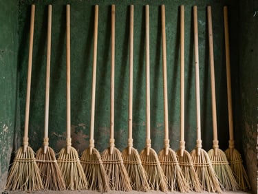 Drying kiln interior with perfectly aligned rows of wooden broom handles, dramatic workshop lighting, 50mm.