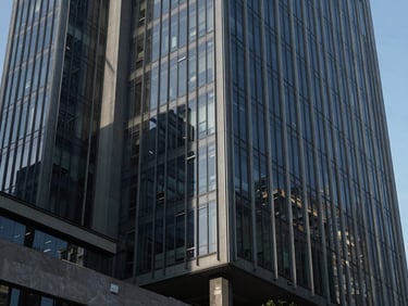 Modern corporate headquarters in Mexico City, sharp architectural shadows, steel and glass facade