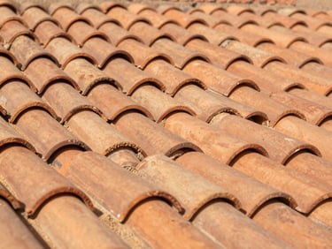 Macro shot of perfectly aligned terracotta roof tiles baking under intense desert sun, high contrast, sharp details.