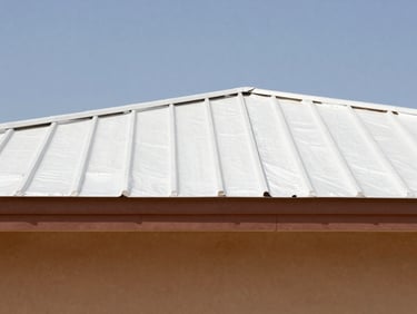 Close-up of a protective white reflective foam roof coating on a modern building, bright sunlight, clear blue sky.
