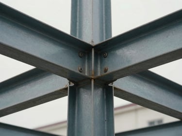 Close-up of architectural joints and material transitions, heavy steel framing, overcast daylight emphasizing form and texture.