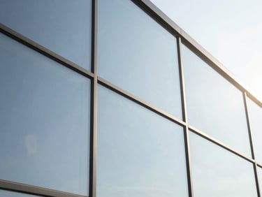 Close-up of a flawless glass window installation, emphasizing micro-thin precision edges and clean architectural lines.