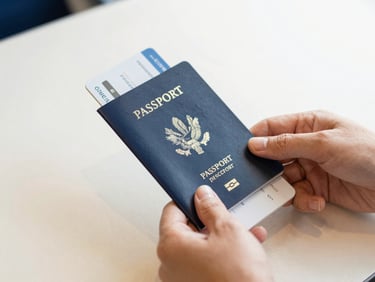 Close-up of hands holding a passport and boarding pass on a clean, light surface, soft natural daylight, shallow depth of field, warm editorial photography