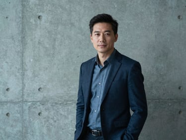 Portrait of a creative director in a modern concrete studio, soft cool lighting, professional photography