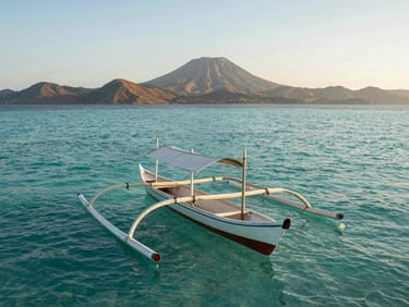 Wide cinematic shot of a traditional wooden outrigger boat floating on crystal clear turquoise water in Lombok, soft morning golden light, volcanic hills in the far background, minimalist composition.