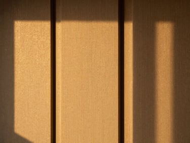 Close-up of three-dimensional fluted WPC wall panels and premium textured wallpaper, architectural shadow play