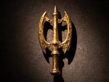Close-up of a 14th-century gilded bronze vajra, dramatic single-source window light, rich metallic textures, dark stone background