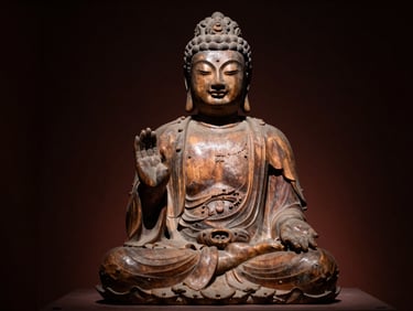 Low-key museum photography of a Heian-era wooden Buddha sculpture, dramatic side-lighting, rich warm wood textures, deep shadows