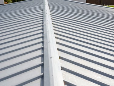 Close-up of a perfect standing-seam metal roof installation, crisp clean lines, sharp focus on the flawless joint, bright natural daylight