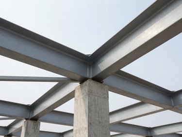 Crisp architectural close-up of structural steel beams and concrete connections on an active site.