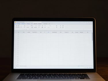 Macro shot of a clean spreadsheet template on a premium laptop screen, glowing in a dark room, gold accent highlights, sharp focus
