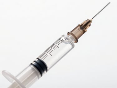 Macro shot of clear gel syringe with FineLine hyaluronic acid, showing viscosity and crystal-like purity under sharp studio light, minimalist white background