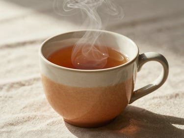 Close-up of a warm ceramic mug of tea with soft steam rising, resting on a textured linen tablecloth in morning light.