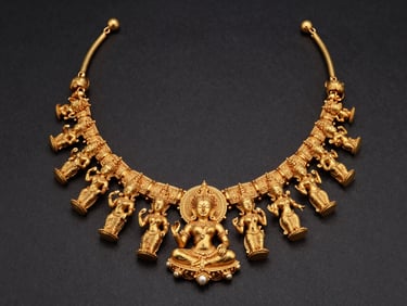 Chiaroscuro studio shot of a heavy temple gold necklace featuring hand-carved divine figures, gleaming against a deep charcoal background.